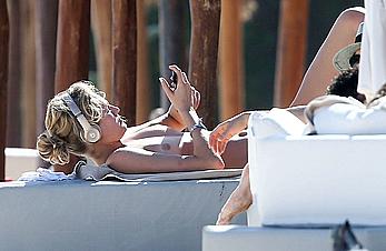 Toni Garrn sunbathing topless on the beach in Miami