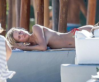 Toni Garrn sunbathing topless on the beach in Miami