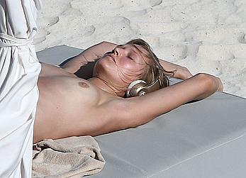 Toni Garrn sunbathing topless on the beach in Miami