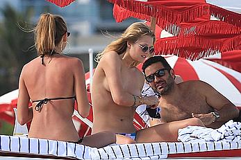 Toni Garrn topless on a beach with friends