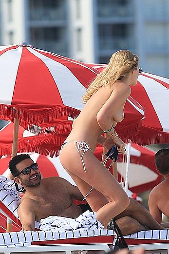 Toni Garrn topless on a beach with friends