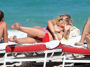 Toni Garrn topless on a beach in Miami