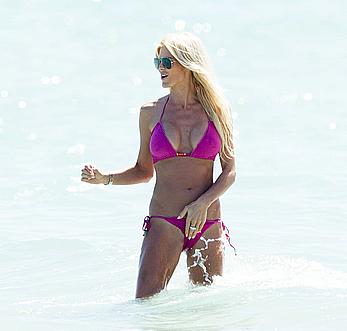 Victoria Silvstedt in pink bikini enjoys and relaxes in the sun at Miami Beach