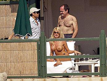 Vistoria Silvstedt sunbathing topless on a beach paparazzi photos