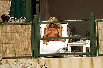 Vistoria Silvstedt sunbathing topless on a beach paparazzi photos