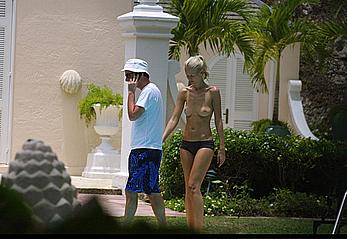 German supermodel Claudia Schiffer topless poolside paparazzi shots