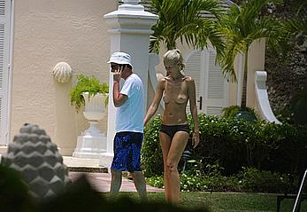 German supermodel Claudia Schiffer topless poolside paparazzi shots