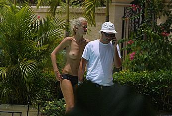 German supermodel Claudia Schiffer topless poolside paparazzi shots