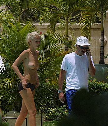 German supermodel Claudia Schiffer topless poolside paparazzi shots