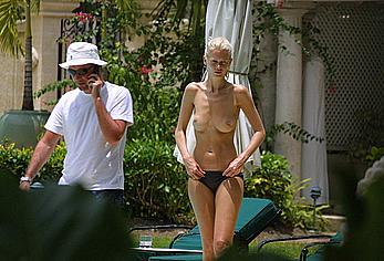 German supermodel Claudia Schiffer topless poolside paparazzi shots