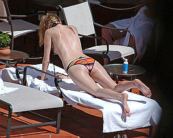 Mischa Barton caught topless on a beach